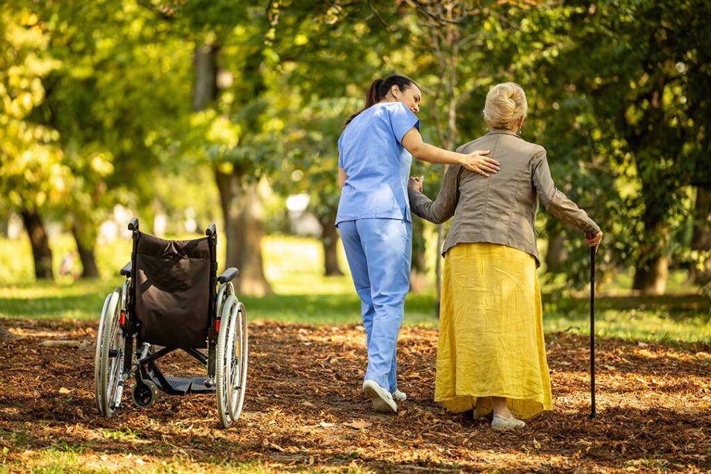 Family members review care documents with an assisted living nurse at a quiet table.