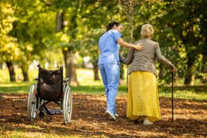 Family members review care documents with an assisted living nurse at a quiet table.